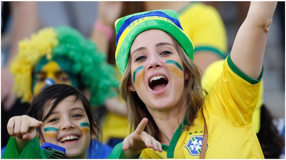 Fans cheer before the start of the group A World Cup soccer match between Brazil and Croatia, the opening game of the tournament, in the Itaquerao Stadium in Sao Paulo, Brazil, Thursday, June 12, 2014. 